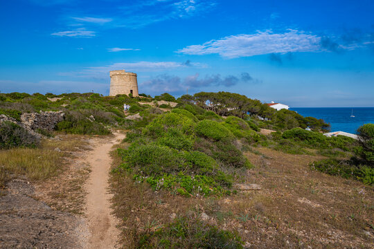 View of Torre de Son Ganxo and lighthouse on Illa de I'Aire, Punta Prima, Menorca, Balearic Islands