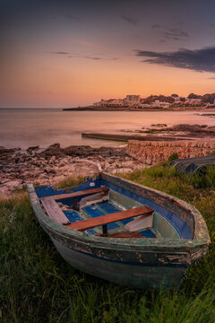 View of Playa Punta Prima and rowing boat at dusk, Punta Prima, Menorca, Balearic Islands