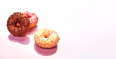 colorful donuts on purple background. Copy space