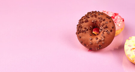 colorful donuts on purple background. Copy space
