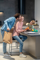 Man kissing his wife after coming from food shopping