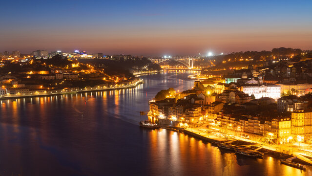 Fototapeta Skyline of the historic city of Porto at night with the bridge Ponte de Arrabida in the background, Oporto, Portugal