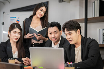 A group of young Asian businessmen Talking and planning work happily and have fun. at the company's office