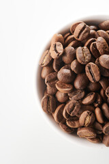 Roasted coffee beans in bowl isolated close up on white background, clipping path