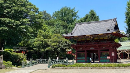 Fototapeta na wymiar The “Shinkyo” bridge that leads to the two story gate of “Nezu” shrine, the honorable historic landmark on its purification ceremonial month, year 2022 June 28th