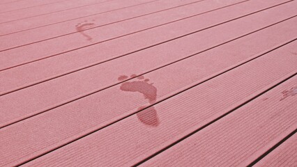 Wet Bare Foot Footprints on Composite Planks Rough Surface