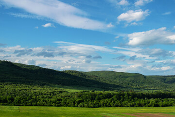 Fototapeta premium Beautiful blue sky and green mountain landscape in Ukraine. Carpathian mounts as a travel destination. Alpine vacation for summertime