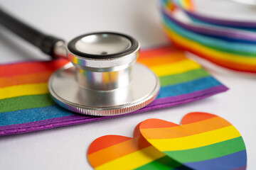 Black stethoscope with rainbow flag heart on white background, symbol of LGBT pride month ...