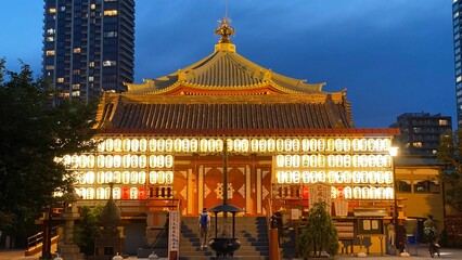 Plakat Beautiful scenery of night temple at Tokyo downtown, Ueno “Bentendo” temple on the island of a pond, vivid beautiful sky contrast and the golden paper lantern lights. Year 2022 June 25th