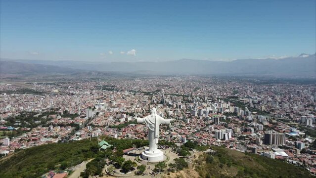 Cristo de la Concordia Jesus statue in bolivia pull back aerial reveal over city