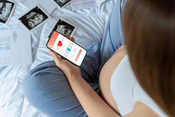 Pregnancy app. Mobile pregnancy online maternity application. Pregnant mother using phone. Pregnancy, medicine, pharmaceutics, health care and people concept.