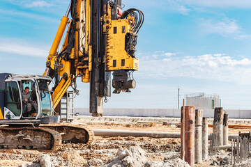 Hydraulic drilling machine at the construction site. Pile field. Modern drilling rig. The device of...