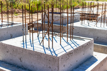Monolithic reinforced concrete foundations for the construction of a residential building. Grillage at the construction site. Construction pit with foundations.
