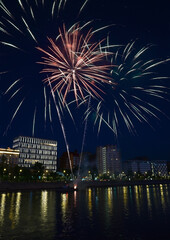 Colorful fireworks near water