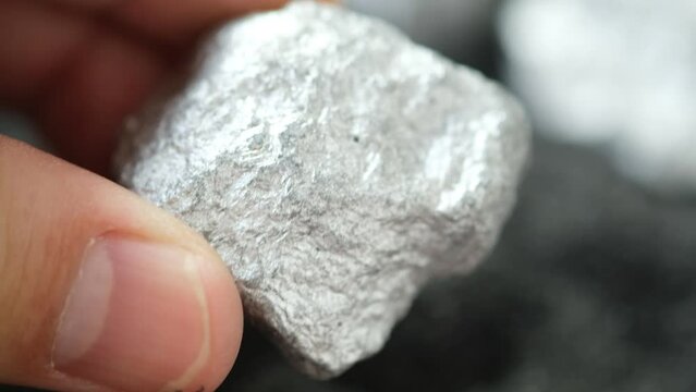 Miners hold platinum or silver in their hands 