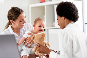 The consultant pediatrician with the baby patient and mother