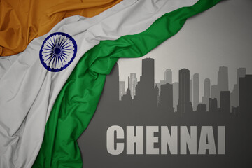 abstract silhouette of the city with text Chennai near waving national flag of india on a gray...