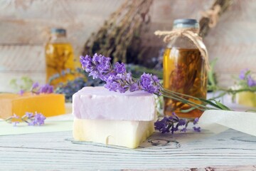 Obraz na płótnie Canvas Lavender flowers, soap, oils and tinctures, on a wooden background, natural ingredients, alternative medicine