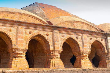 Fototapeta na wymiar Arches of Rasmancha, oldest brick temple of India -tourist attraction in Bishnupur, West Bengal, India. Terracotta-burnt clay-structure is unique. Hindu deities were worshipped here in Ras festival.
