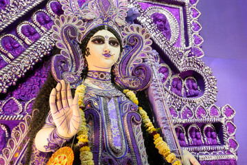 Fototapeta premium Blessing hand , Idol of Goddess Saraswati at Kolkata, West Bengal, India. Saraswati is Hindu goddess of knowledge, music, art, wisdom, and learning. Worshipping is done in spring in India.