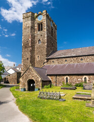Fototapeta na wymiar Solid stone tower and structure of St Mary Church and graveyard in the historic town of Conwy in Wales