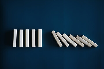 Closeup thick domino wood block in a row stop the falling, be stable in crisis, business solution concept