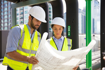 Make and Female engineer concentrate working on drawing at construction site line