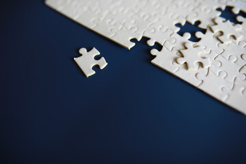 Clean puzzle elements on the background. Empty puzzle piece on the table. Teamwork concept.