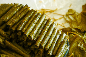 a cook making stuffed leaves, making stuffed leaves at home, stuffed leaves from Turkish cuisine,