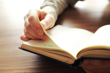 Reading religious literature. Open book. Man reads bible or Koran.