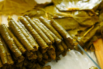 a cook making stuffed leaves, making stuffed leaves at home, stuffed leaves from Turkish cuisine,