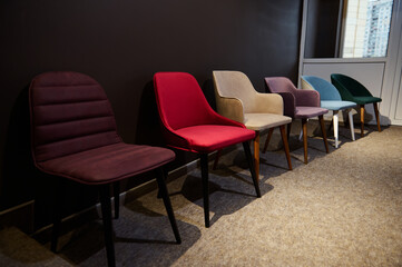 Naklejka na ściany i meble Retro style colorful chairs, on dispay for sale in the furniture store showroom