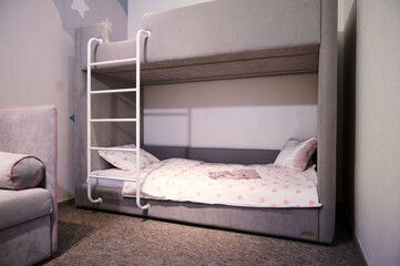 Comfortable bunk bed family bedroom concept idea. Stylish kids bedroom. Model of designed children bedchamber displayed for sale in furniture showroom