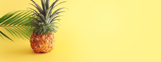 Ripe pineapple over yellow background. Beach and tropical theme