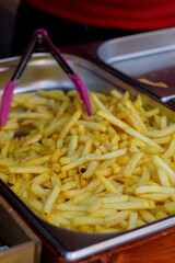 Overhead view of golden deep fried French fries food in full frame closeup.