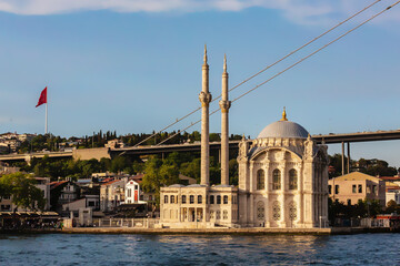 Fototapeta na wymiar Istanbul, Turkey (Turkiye). Ortakoy Mosque as seen from Bosphorus at golden hour on summer day. Amazing masterpiece of Ottoman baroque, XIX century. Turism or history of architecture concept