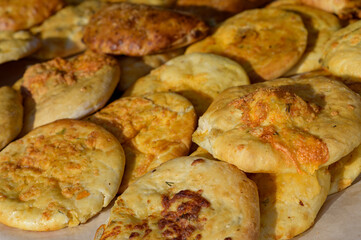 Hungarian street food - langos. Flatbread with sour cream-garlic sauce and cheese