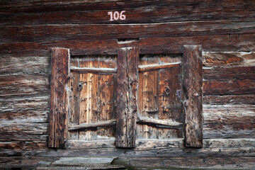 Old wooden barn's door of a Swiss chalet in the Alps