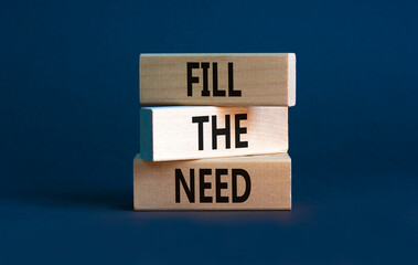 Fill the need symbol. Concept words Fill the need on wooden blocks on a beautiful grey table grey...