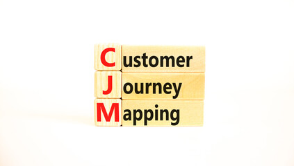 CJM customer journey mapping symbol. Concept words CJM customer journey mapping on wooden blocks on a beautiful white background. Business and CJM customer journey mapping concept. Copy space.