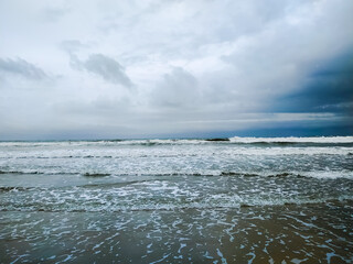 Storm over waves on the beach