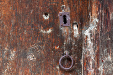 old rusty lock in an old wooden door