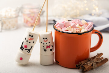 Hot chocolate mug with melted marshmallow snowman.Sweet treat for kids funny marshmallow snowman. Christmas winter holiday decoration. New Year card.Winter hot drink.