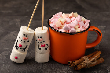 Hot chocolate mug with melted marshmallow snowman.Sweet treat for kids funny marshmallow snowman. Christmas winter holiday decoration. New Year card.Winter hot drink.