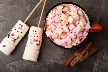 Hot chocolate mug with melted marshmallow snowman.Sweet treat for kids funny marshmallow snowman. Christmas winter holiday decoration. New Year card.Winter hot drink.