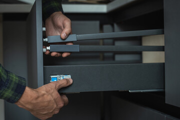 Furniture maker assembling new modern drawer system with adjustment mechanism