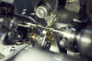 Close-up of processing metal part using fluid on modern lathe with coolant lubricant system