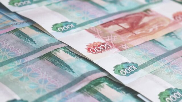 Money background from moving banknotes of Russian rubles.