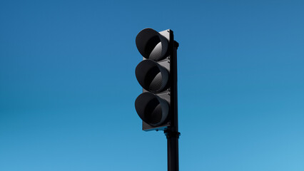 not working or turned off triple black traffic light isolated on blue sky background. Mock-up or...