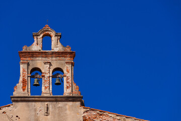 Fototapeta na wymiar Religious architecture in Pisa. Ruins of an ancient belfry (with blue sky and copy space)